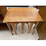 A NEST OF FOUR TEAK TABLES, THREE BEING OVAL DROP-LEAF