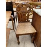 A VICTORIAN OAK HALL CHAIR ON TURNED FRONT LEGS