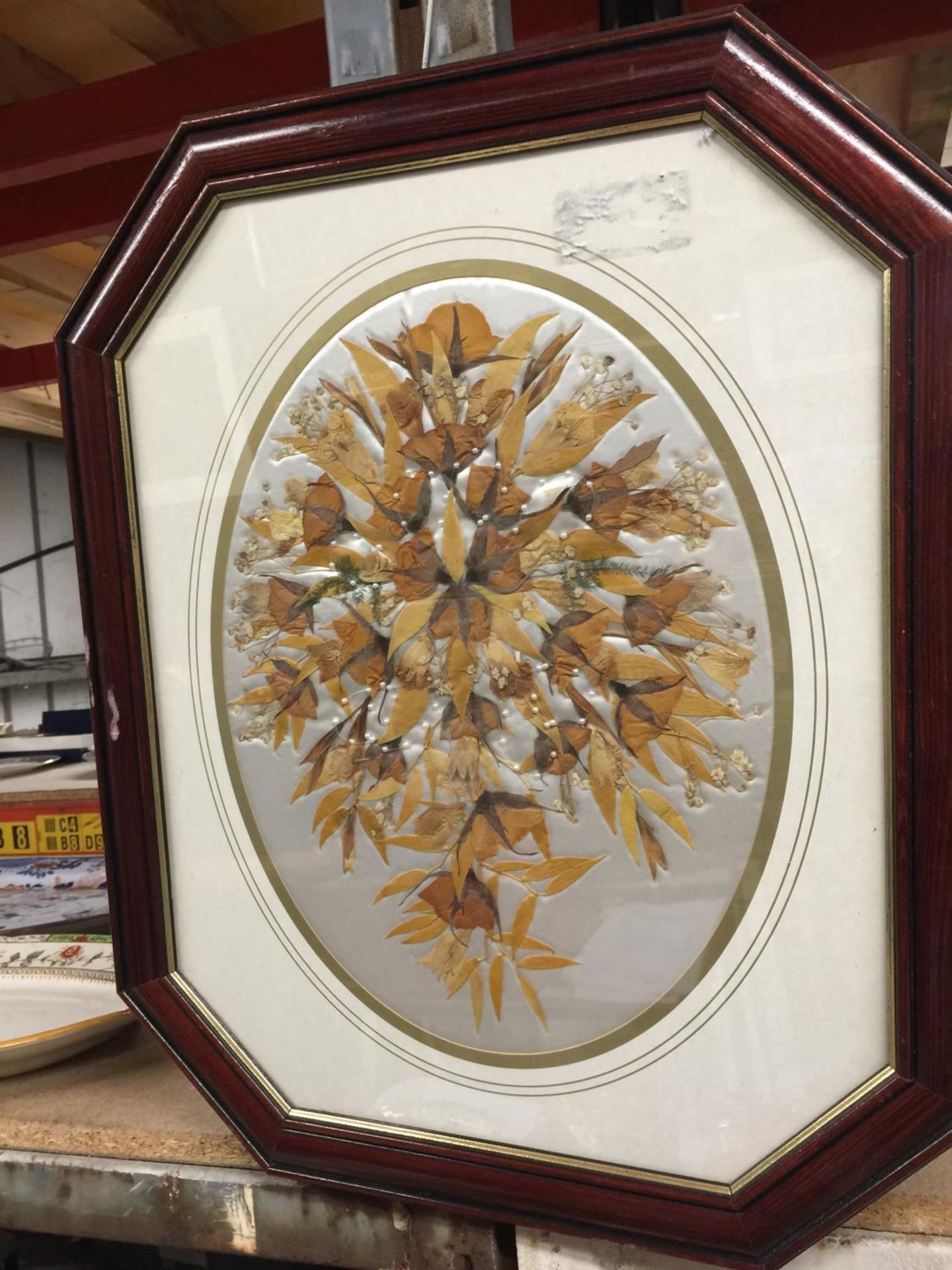 A 'LEAF' PICTURE ON CUSHIONED BACKGROUND IN AN OCTAGONAL FRAME