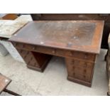 A VICTORIAN MAHOGANY TWIN PEDESTAL DESK ENCLOSING NINE DRAWERS, 48X24" WITH INSET LEATHER TOP