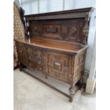 AN EARLY 20TH CENTURY OAK JACOBEAN STYLE SIDEBOARD WITH RAISED BACK, 72" WIDE