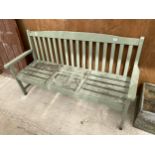 A WOODEN SLATTED GARDEN BENCH