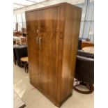 A WALNUT WARING & GILLOW TWO DOOR WARDROBE