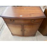 A MODERN YEW WOOD BOWFRONTED SIDEBOARD WITH TWO DRAWERS AND TWO CUPBOARDS, 31" WIDE