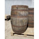 A VINTAGE OAK AND METAL BANDED WHISKEY BARREL