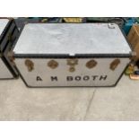 A METAL TRAVEL TRUNK WITH BRASS FITTINGS BEARING THE NAME 'A M BOOTH'