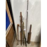 A COLLECTION OF VINTAGE ITEMS TO INCLUDE FISHING RODS, WALKING STICKS AND A CRICKET BAT