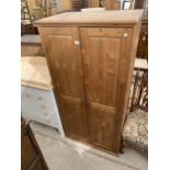 A MODERN PINE TWO DOOR WARDROBE, 31" WIDE