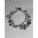 A SILVER CHARM BRACELET WITH EIGHTEEN CHARMS