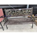 A WOODEN SLATTED GARDEN BENCH WITH CAST IRON BENCH ENDS AND CAST BACK