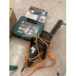 AN ASSORTMENT OF TOOLS TO INCLUDE A BOSCH DRILL AND A BLACK AND DECKER ELECTRIC HEDGE TRIMMER