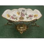 A DECORATIVE CERAMIC TAZZA FRUIT BOWL WITH GILDING ON BRASS ROCOCO STYLE STAND H: 23CM W: 38CM