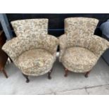 A PAIR WINGED ARM BEDROOM CHAIRS ON FRONT CABRIOLE LEGS