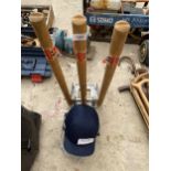 A SET OF SPRUNG CRICKET STUMPS AND A CRICKET HELMET