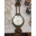 AN ARTS AND CRAFTS STYLE OAK CASED BAROMETER HEIGHT 52CM