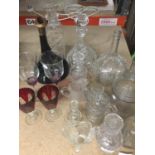 A QUANTITY OF GLASSWARE TO INCLUDE DECANTERS, JUGS, WINE GLASSES, ETC