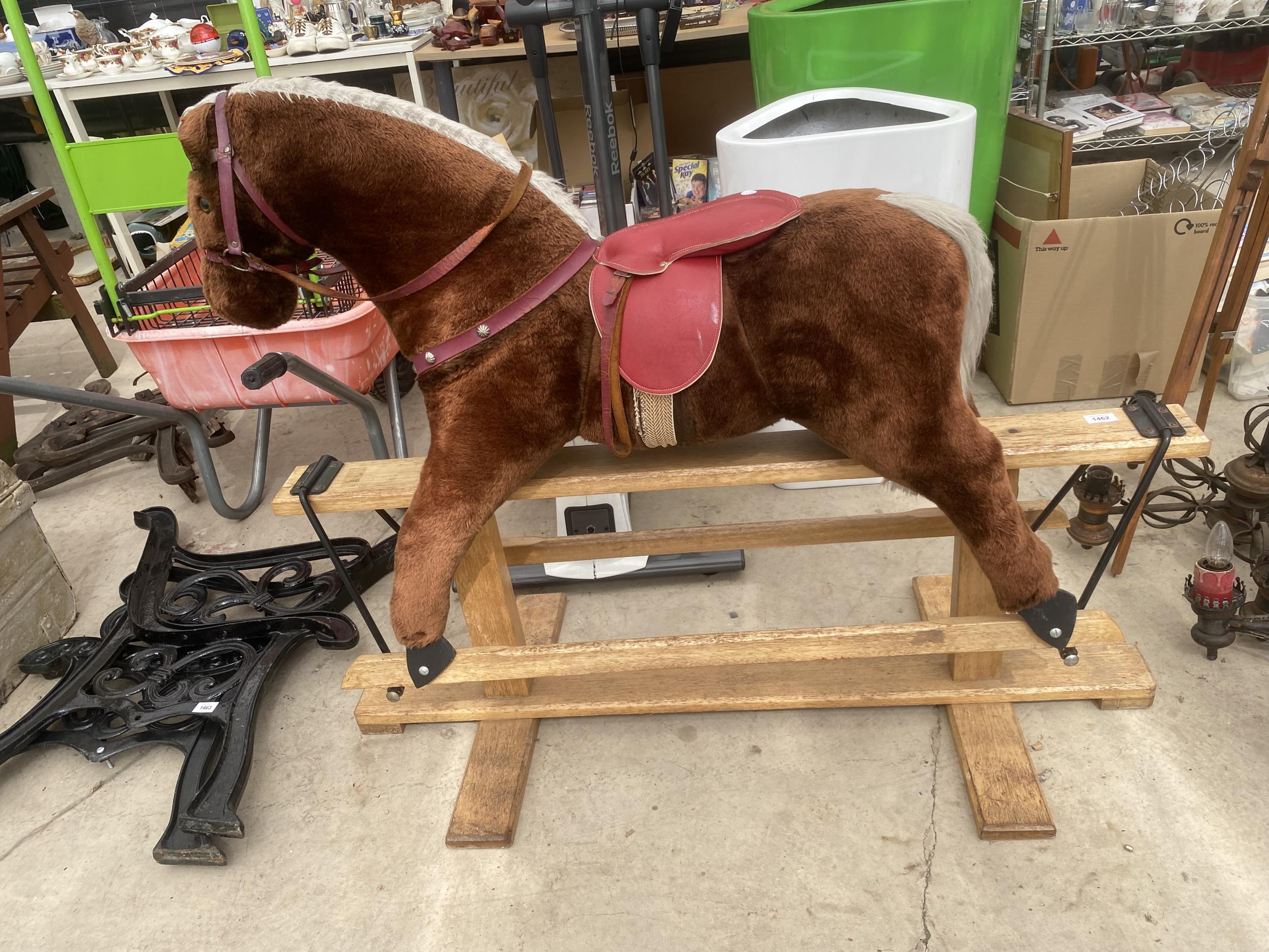 A PLUSH CHILDRENS ROCKING HORSE WITH WOODEN FRAME