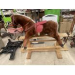 A PLUSH CHILDRENS ROCKING HORSE WITH WOODEN FRAME