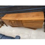 A REETRO TEAK 'BEAUTILITY' SIDEBOARD ENCLOSING THREE DRAWERS AND CUPBOARDS ON SWEPT OPEN BASE, 72"