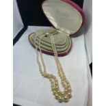 A BOXED DOUBLE STRING OF PEARLS WITH CLASP AND SAFETY CHAIN