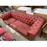 A MODERN RED THREE SEATER CHESTERFIELD SETTEE