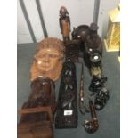 A COLLECTION OF TREEN ITEMS TO INCLUDE CARVED WALL PLAQUES, A TREEN BUST 'ELEPHANT' GOBLET, ELEPHANT