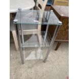 A MODERN THREE TIER GLASS DISPLAY STAND WITH POLISHED CHROME LEGS, 16X12"