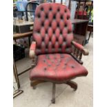 AN OXBLOOD SWIVEL OFFICE CHAIR