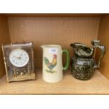 A BRASS ANIVERSARY CLOCK, A WOOD WARE JUG AND A FURTHER CERAMIC JUG