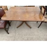 A REGENCY MAHOGANY TILT TOP DINING TABLE, 54X41" ON QUATREFOIL BASE WITH BRASS TERMINALS AND CASTERS