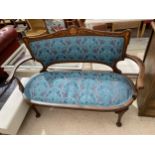 AN EDWARDIAN MAHOGANY AND PROFUSELY INLAID PARLOUR SETTEE ON FRONT CABRIOLE LEGS