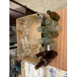 AN ASSORTMENT OF VINTAGE COLOURED GLASS BOTTLES TO INCLUDE SOME BEARING NAMES