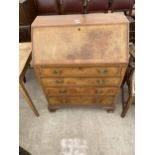 A WALNUT AND CROSSBANDED BUREAU ENCLOSING FOUR GRADUATED DRAWERS, 30" WIDE