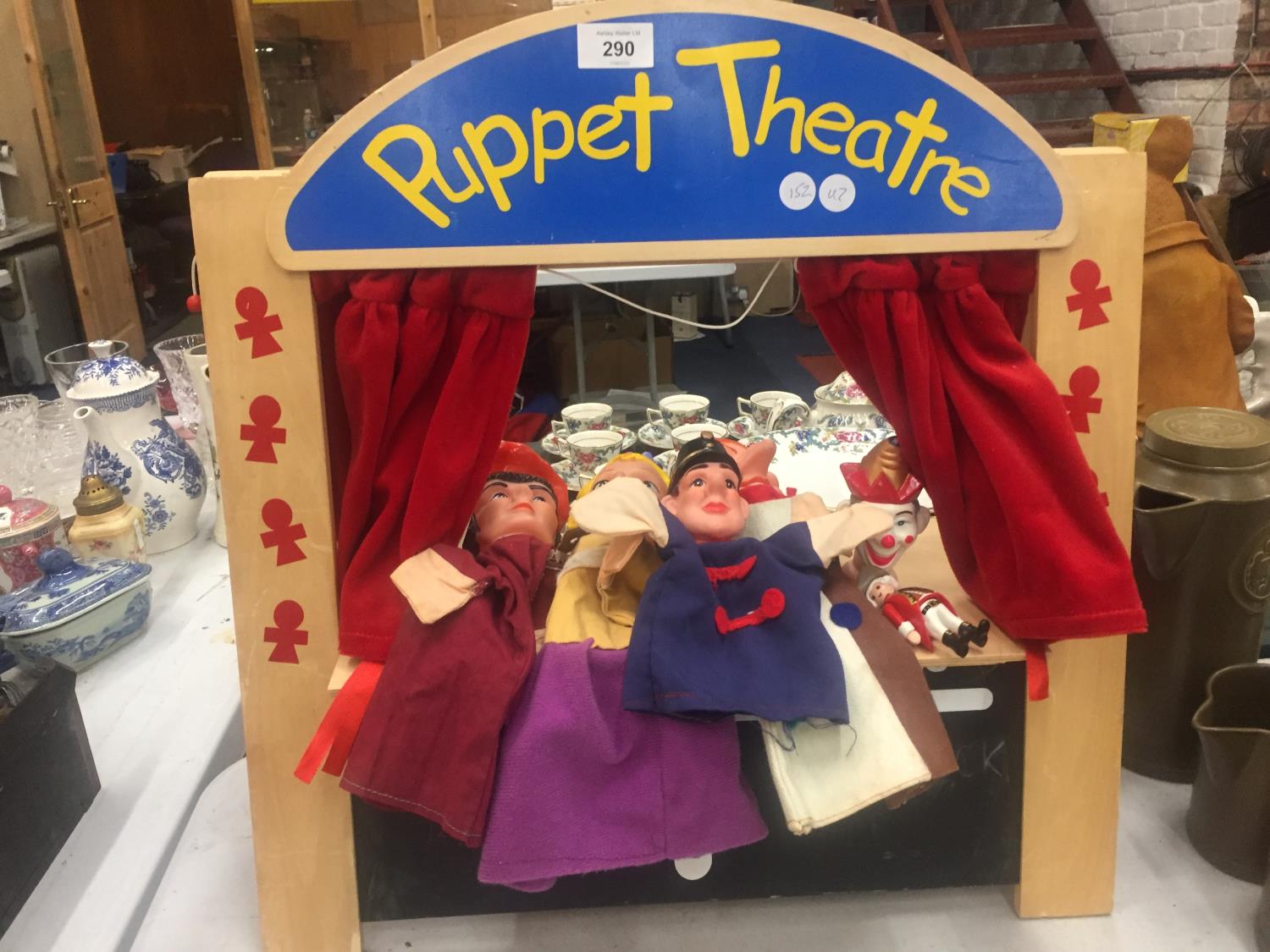 A WOODEN PUPPET THEATRE WITH PUPPETS