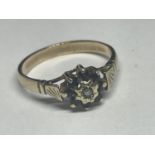 A 9 CARAT GOLD RING WITH A CENTRE DIAMOND AND SAPPHIRES IN A FLOWER DESIGN SIZE K