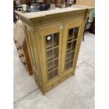 A MODERN PINE GLAZED TWO DOOR CABINET