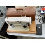 A RETRO FINESE SEWING MACHINE WITH CARRY CASE AND FOOT PEDAL