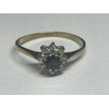 A 9 CARAT GOLD RING WITH A CENTRE SAPPHIRE AND SURROUNDING DIAMONDS SIZE Q/R