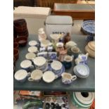 AN ASSORTMENT OF ITEMS TO INCLUDE AN ENAMEL BREAD BIN, CERAMIC JUGS AND BLUE AND WHITE CUPS AND