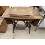 A VINTAGE SINGER SEWING MACHINE WITH CAST TREDDLE BASE