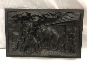 A HEAVY CAST IRON VICTORIAN PLAQUE DEPICTING A FARRIER AND A HORSE