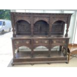 A VICTORIAN WELSH GOTHIC REVIVAL OAK RAISED DRESSER WITH ARCHED UPPER PORTION, DRAGON AND BELLS