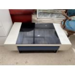 A MODERNIST WHITE COFFEE TABLE WITH BLACK GLASS INSET TOP, SINGLE DRAWER ON POLISHED CHROME BASE,