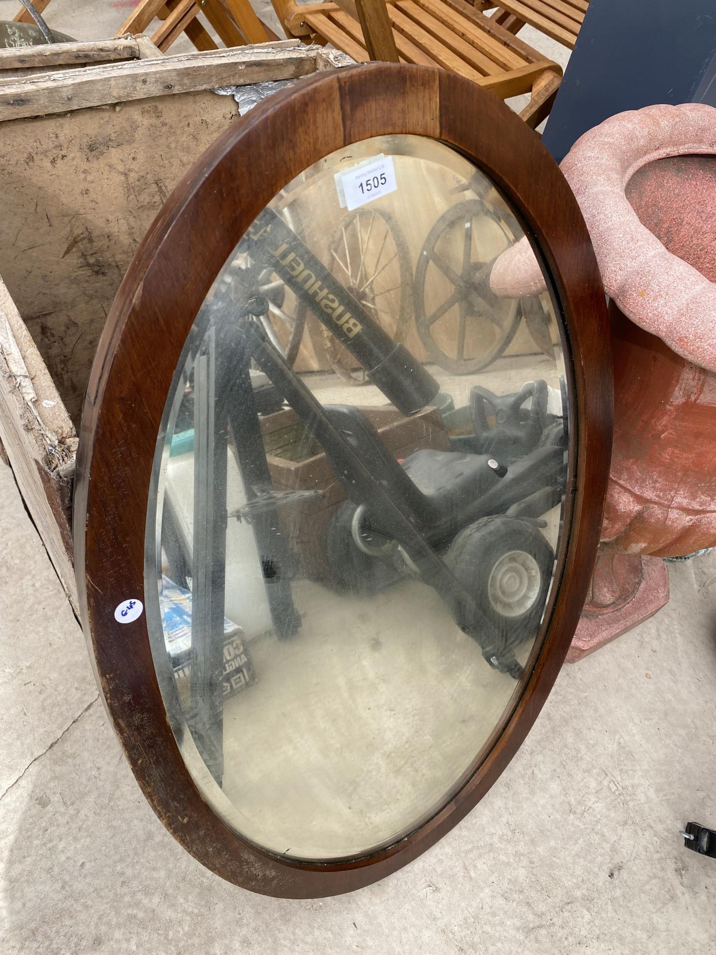 A WOODEN FRAMED BEVEL EDGED WALL MIRROR