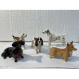 FIVE BESWICK DOGS TO INCLUDE A FOX HOUND, DALMATION, SPANIEL, DASHOUND, AND A CORGI