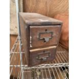 A VINTAGE WOODEN 'MANIFOLDIA' TWO DRAWER INDEX CABINET CONTAING HARDWARE AND ELECTRICAL TAPE