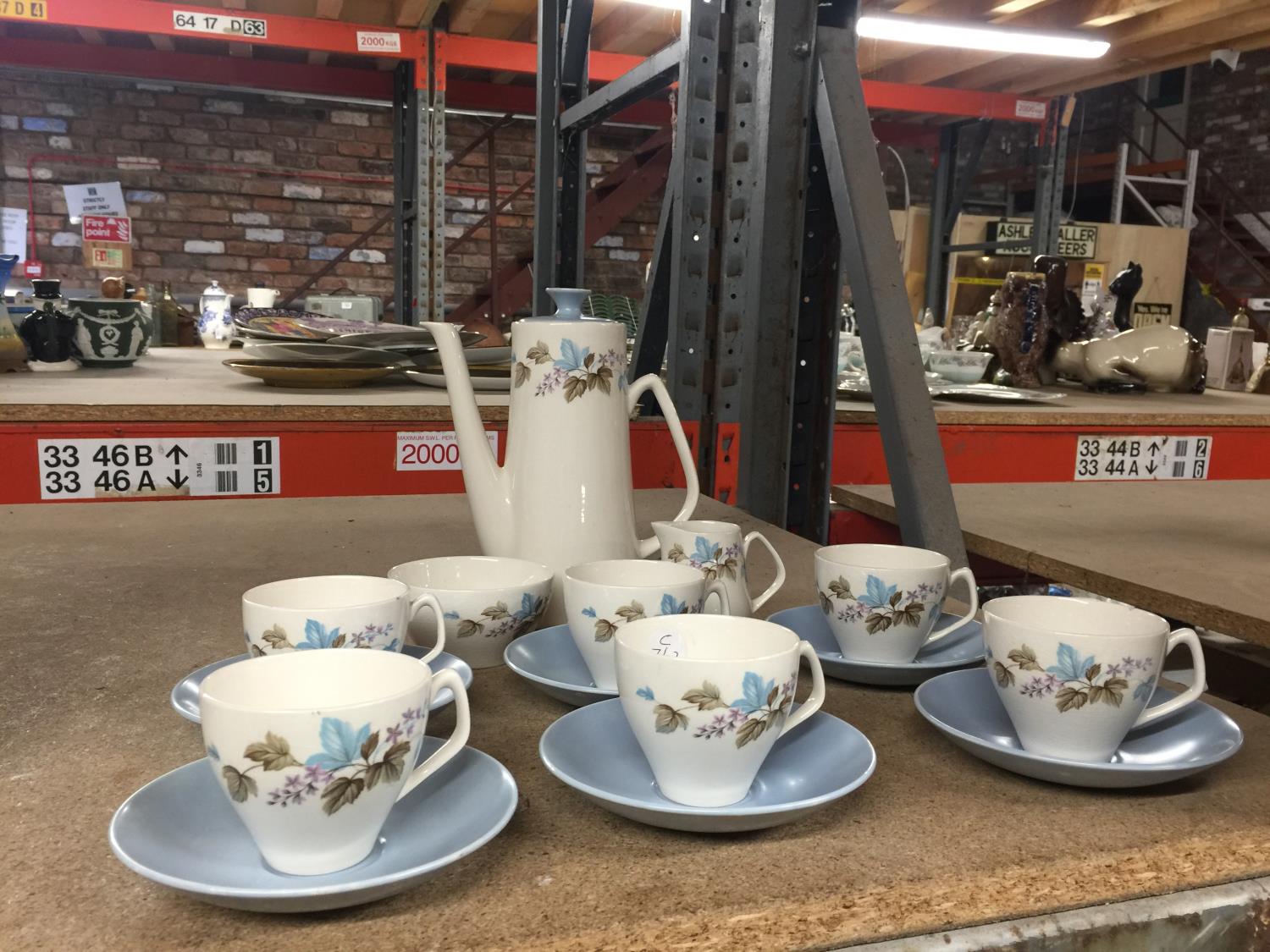 A VINTAGE COFFEE SET IN A PLAE BLUE AND WHITE WITH FOLIAGE DECORATION TO INCLUDE COFFEE POT, CREAM