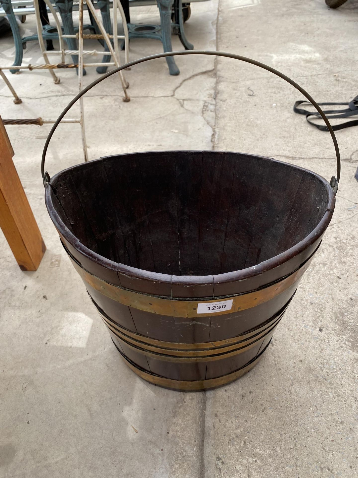 A VINTAGE WOODEN AND BRASS BANDED BUCKET