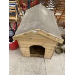 A WOODEN DOG KENNEL WITH FELT ROOF