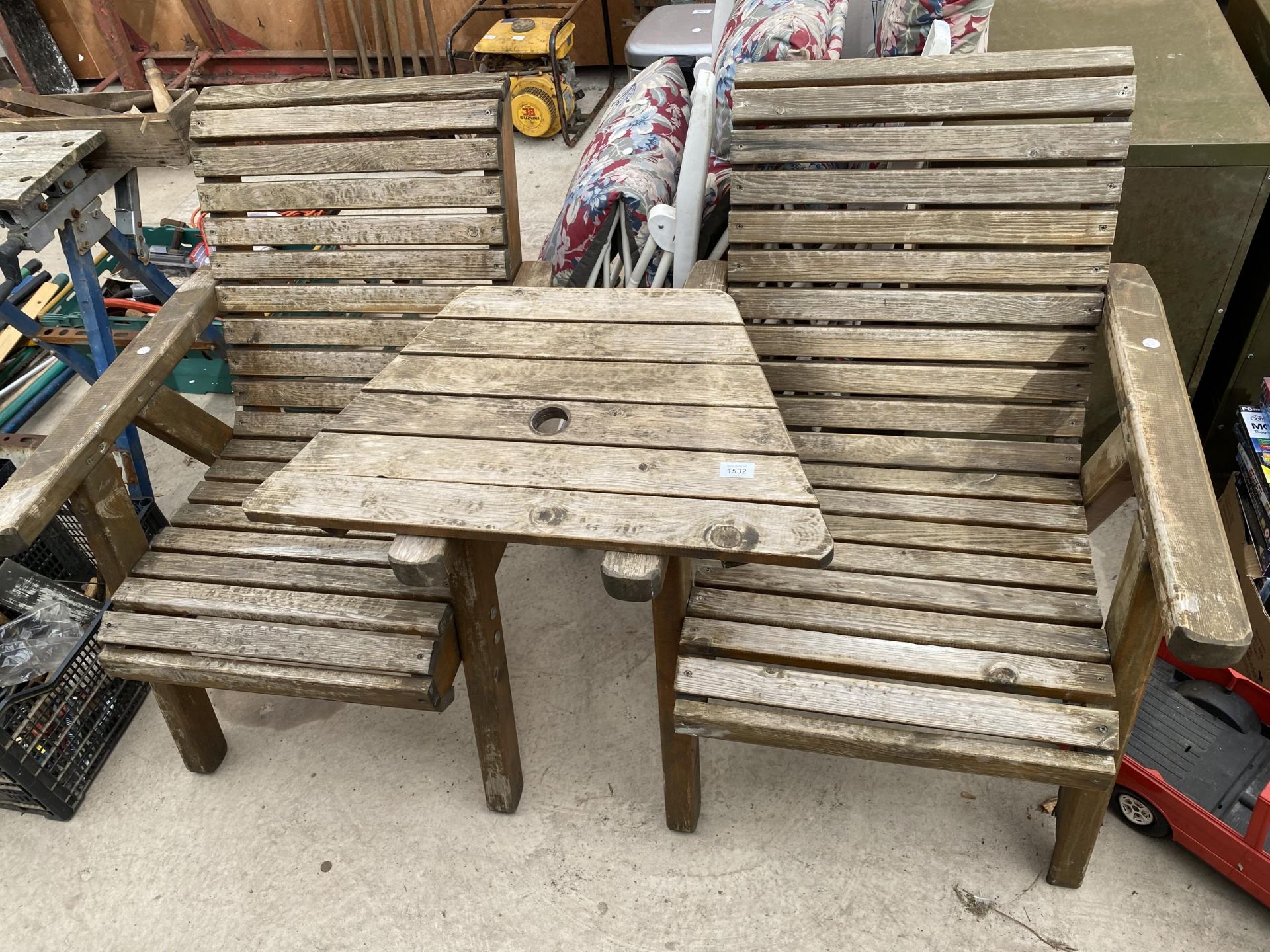 A TEAK GARDEN LOVE SEAT WITH MIDDLE TABLE SECTION